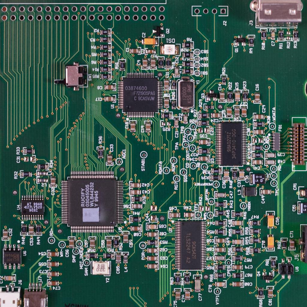 Detailed image of a green circuit board featuring various components and microprocessors.